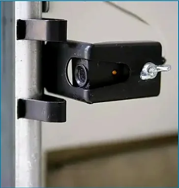 Garage door safety sensor inspection and alignment